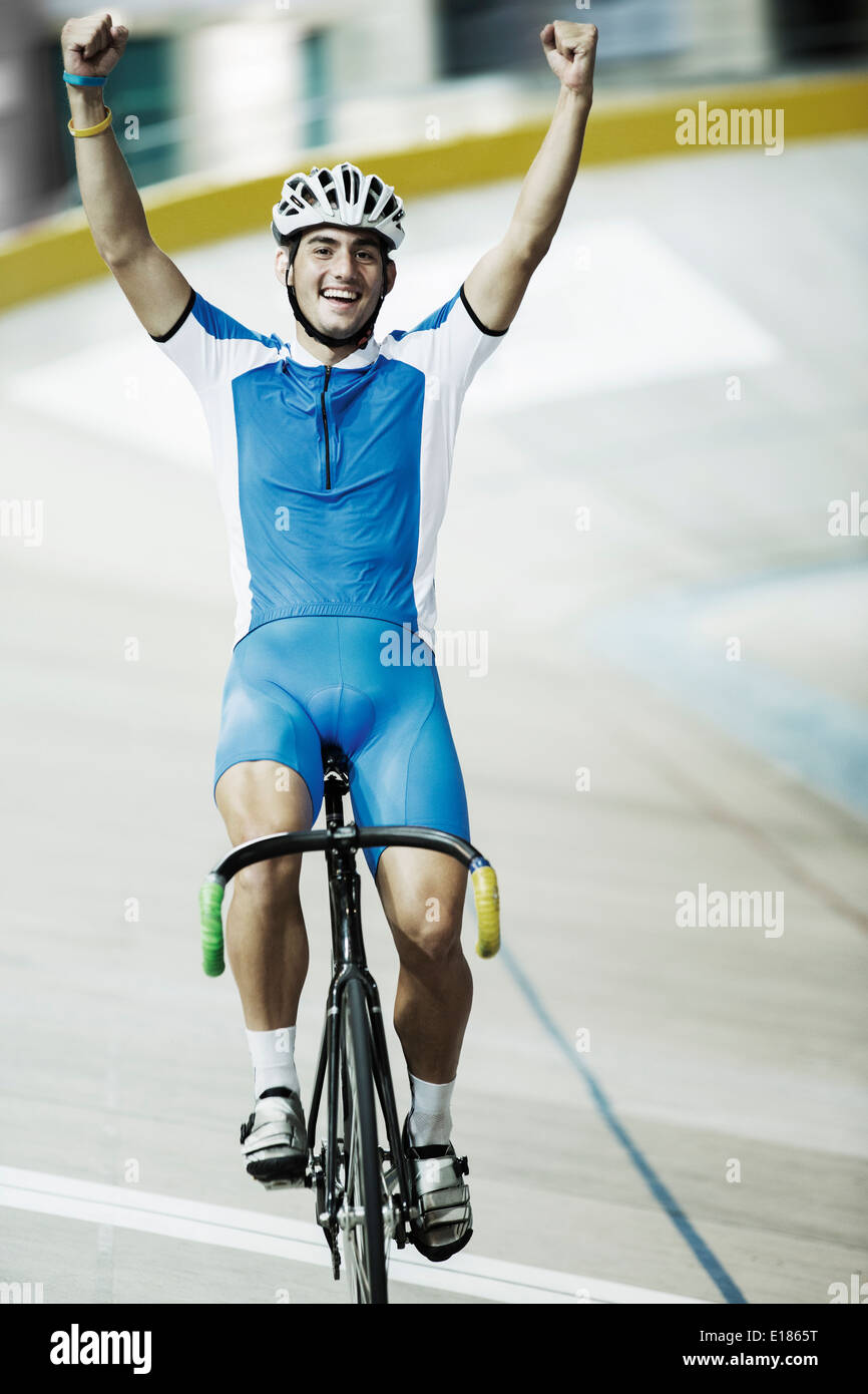Track cyclist celebrating in velodrome Stock Photo