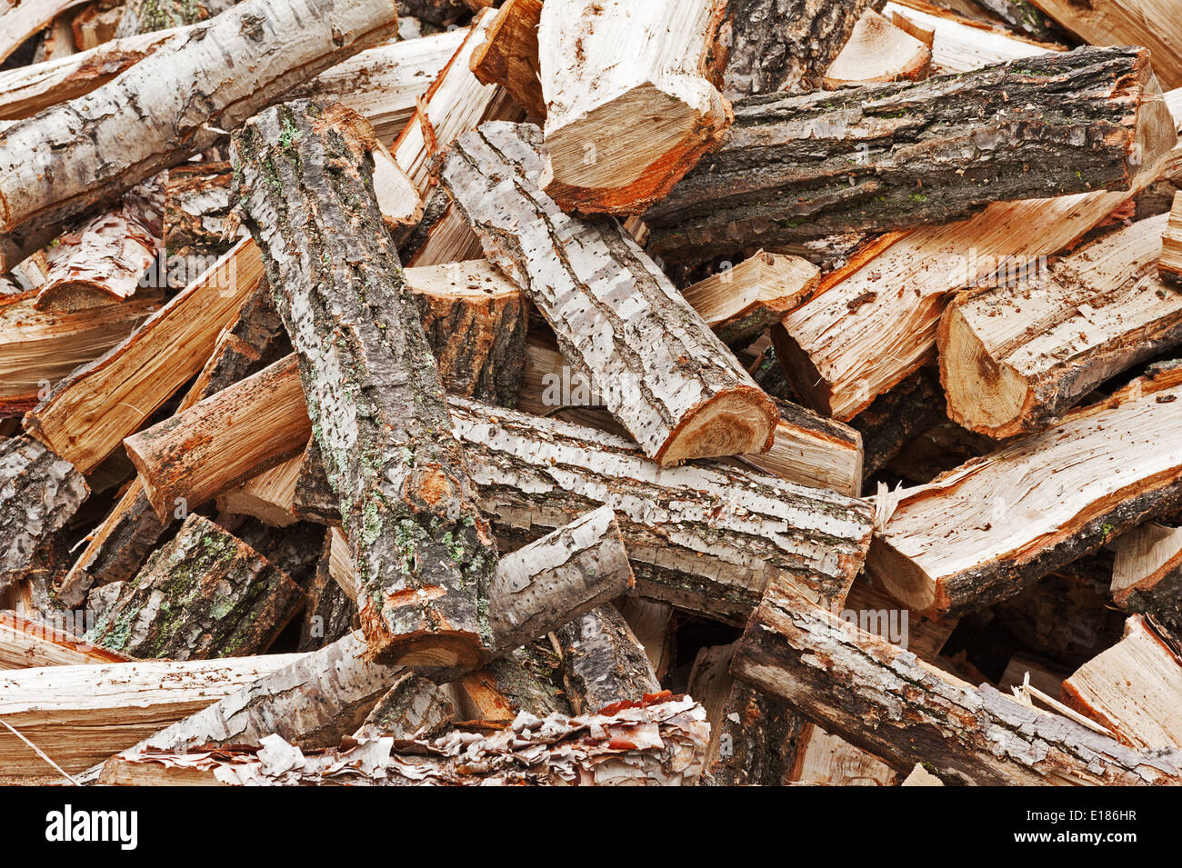 Dry chopped firewood logs in pile. Nature background. Stock Photo