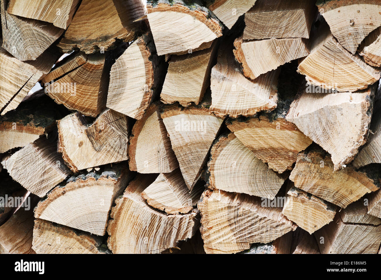 Dry chopped firewood logs in pile. Nature background. Stock Photo