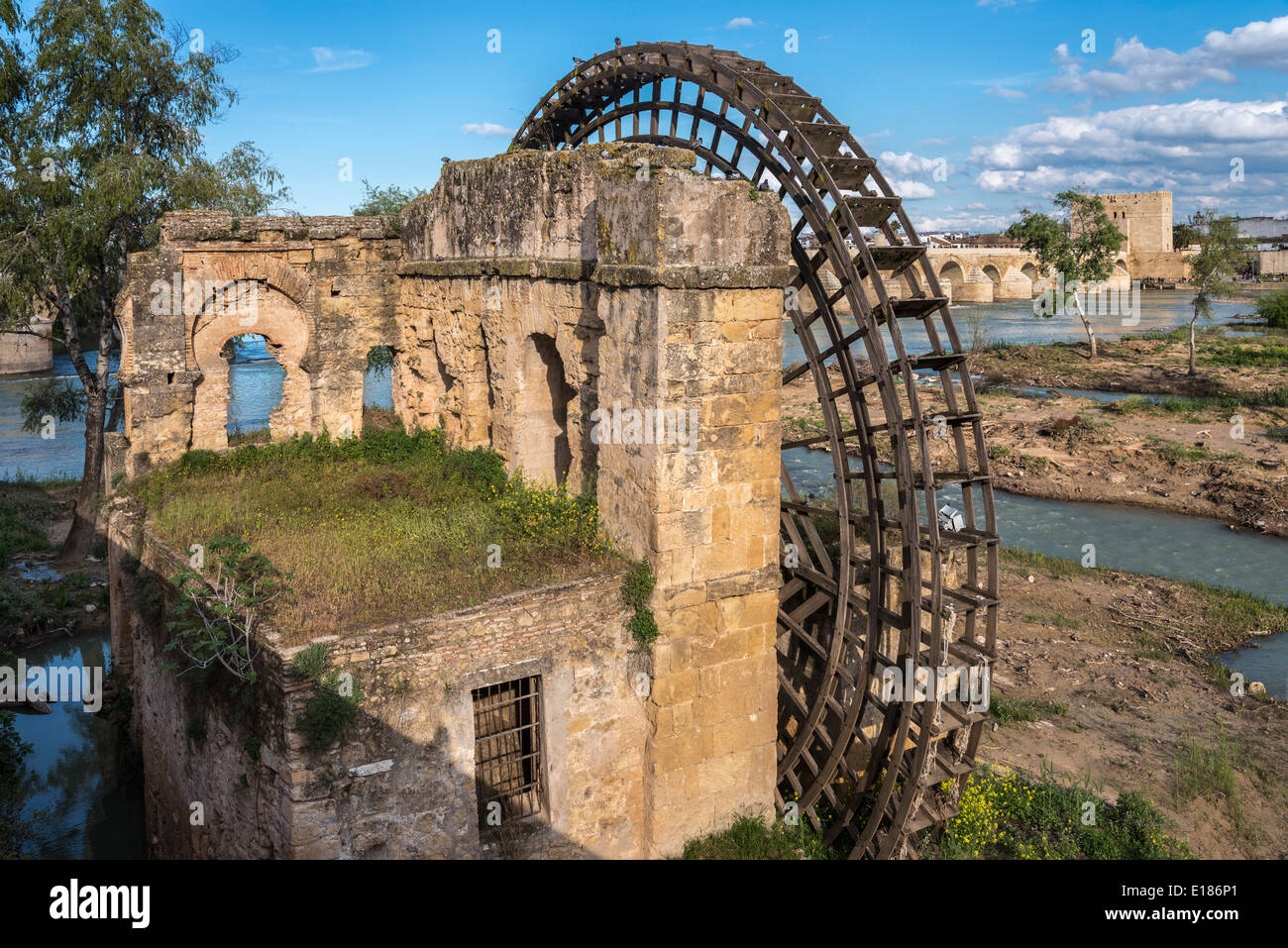 Old water mill on the Guadalquivir river with the Roman bridge and Torre de la Calahorra behind. Cordoba, Andalucia, Spain Stock Photo