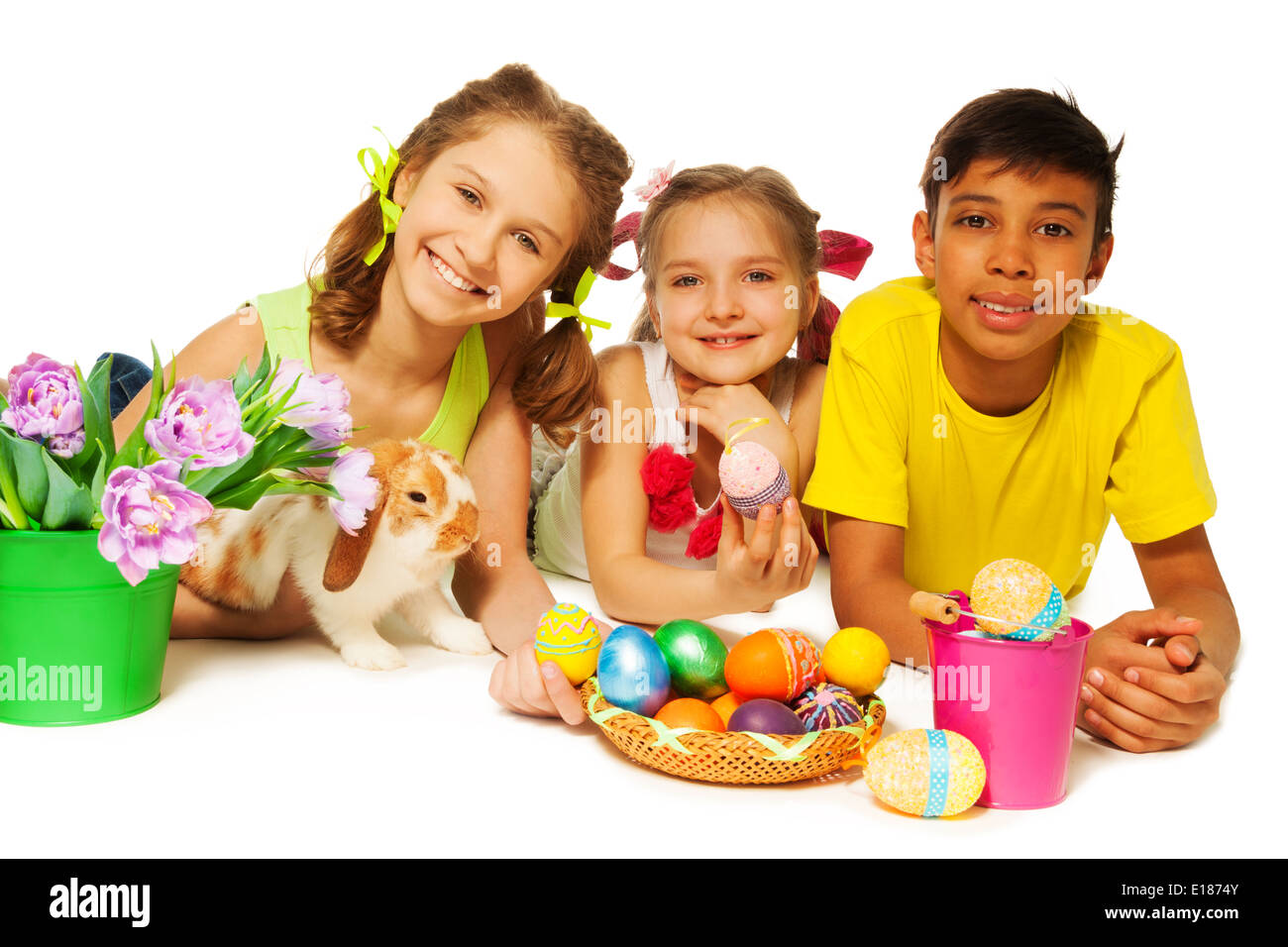 Three smiling kids together with Eastern eggs Stock Photo