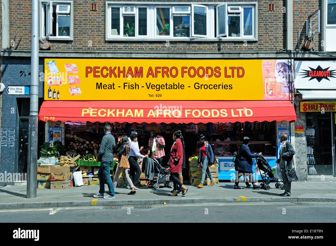 Peckham Afro Foods Ltd shop with passing people, Rye Lane, Peckham