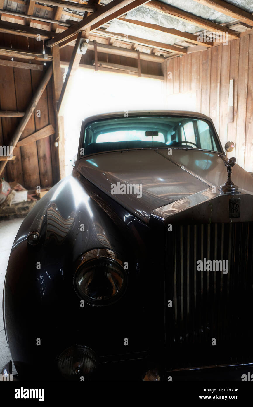 Dusty Rolls Royce in an old barn Stock Photo