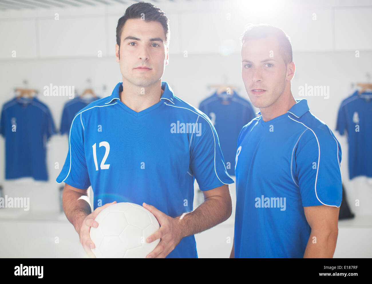 Soccer players standing in locker room Stock Photo