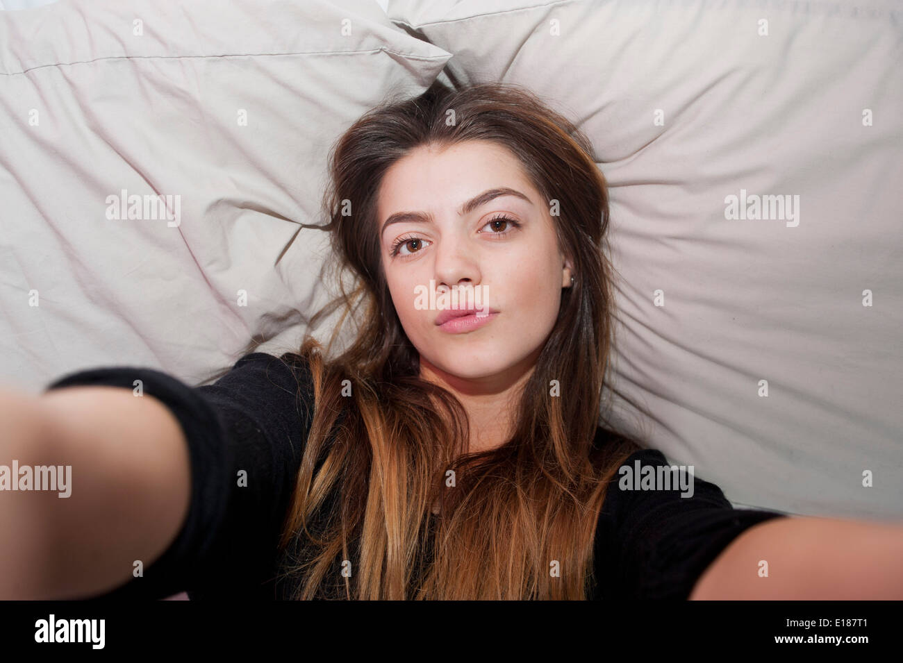 Teenage 13 Year Old Girl Posing For A Pretend Selfie In Her Bedroom