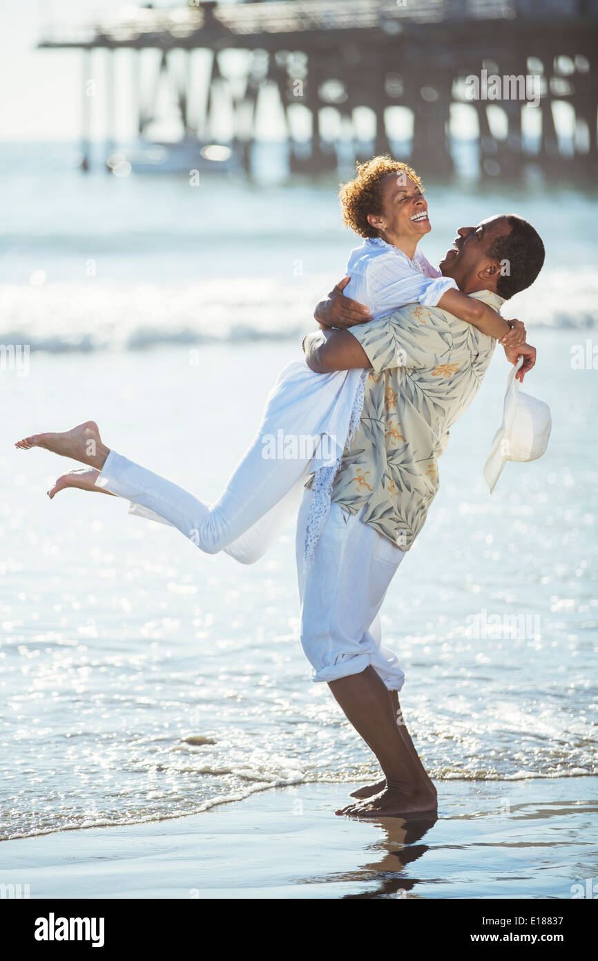 Couple hugging on beach Stock Photo