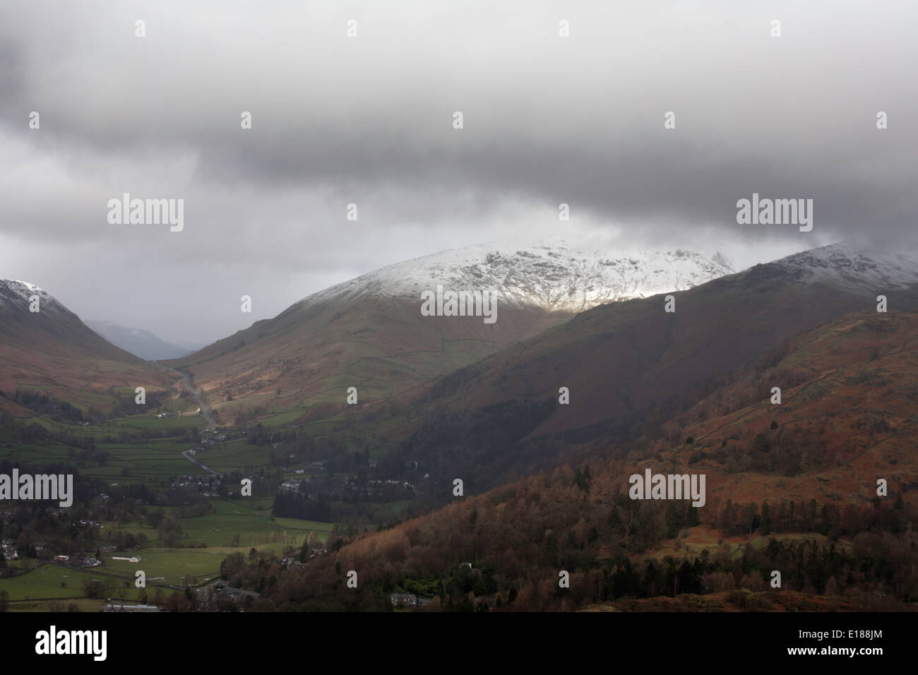 Storm  shower clouds  and snow on the summits of Seat Sandal and Dollywaggon Pike above Grasmere Lake District Cumbria England Stock Photo