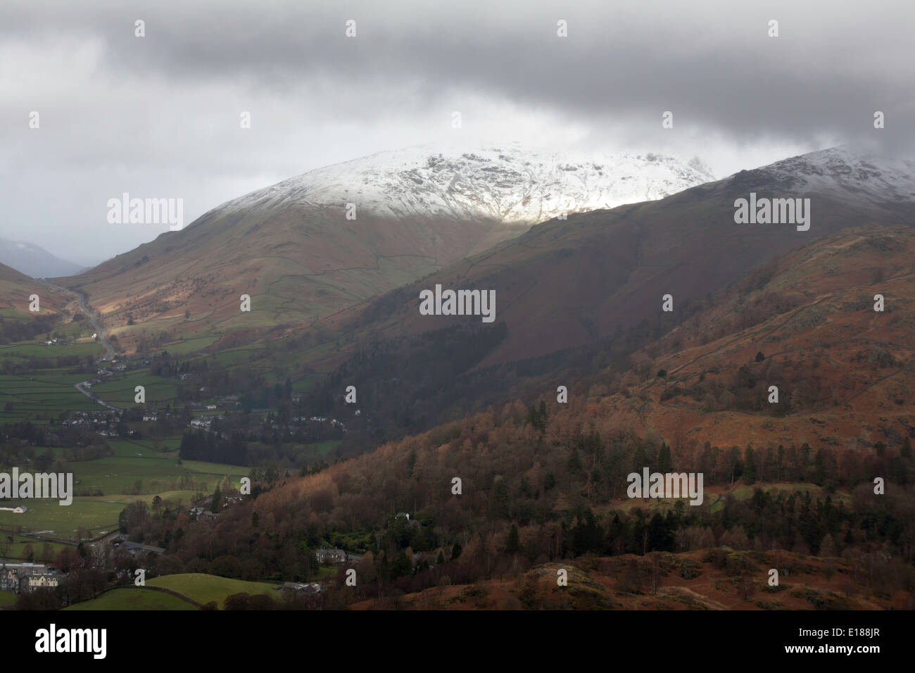 Storm  shower clouds  and snow on the summits of Seat Sandal and Dollywaggon Pike above Grasmere Lake District Cumbria England Stock Photo