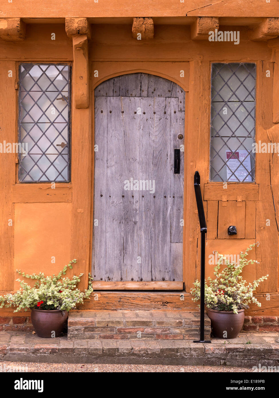 Oak door and leaded windows on old Medieval half timbered oak post and beam house of Little Hall, Lavenham, Suffolk, England, UK Stock Photo