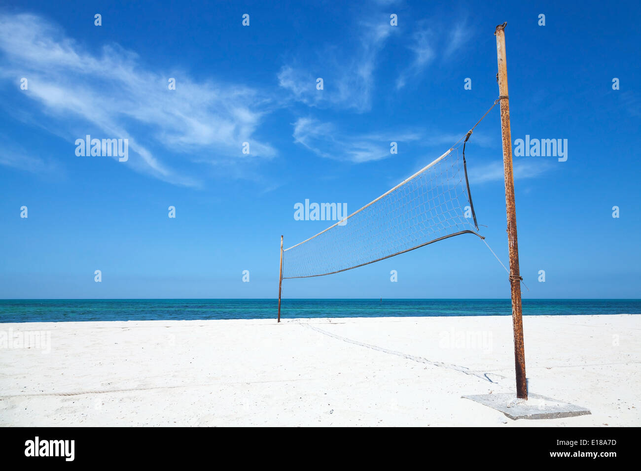 Old net for beach volleyball on empty sea coast Stock Photo