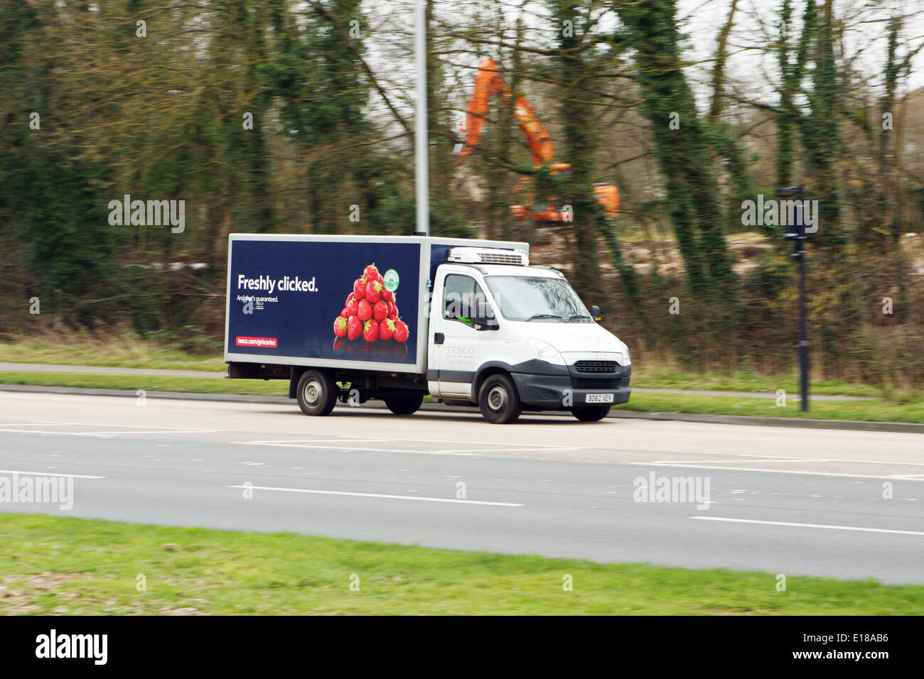 A Tesco home delivery truck traveling along the A23 road in Coulsdon, Surrey, England Stock Photo