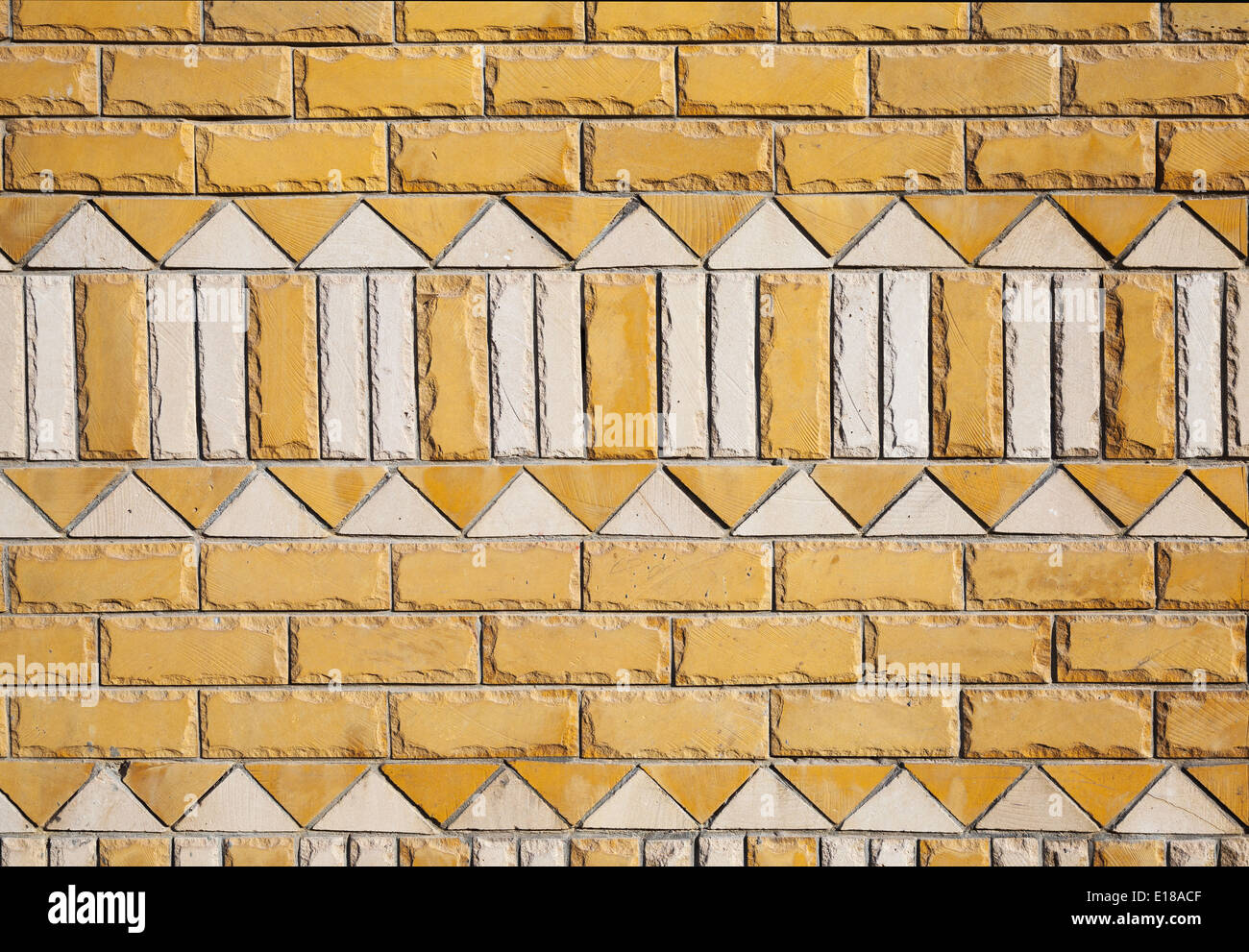 Yellow brick wall texture with white ornament pattern Stock Photo