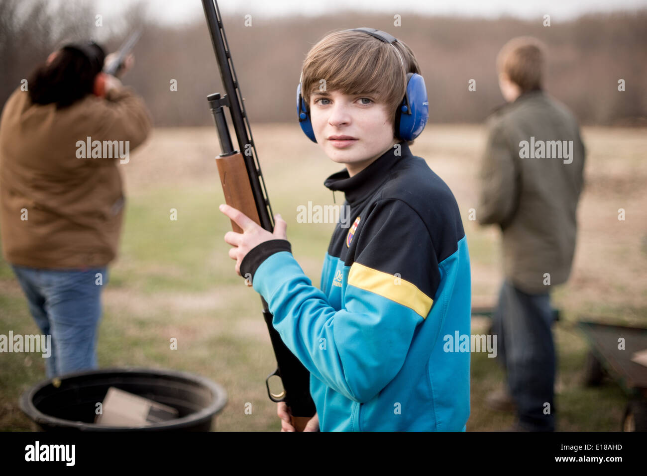 Young man holding rifle, wearing ear protection in Bel Air, Maryland, USA Stock Photo