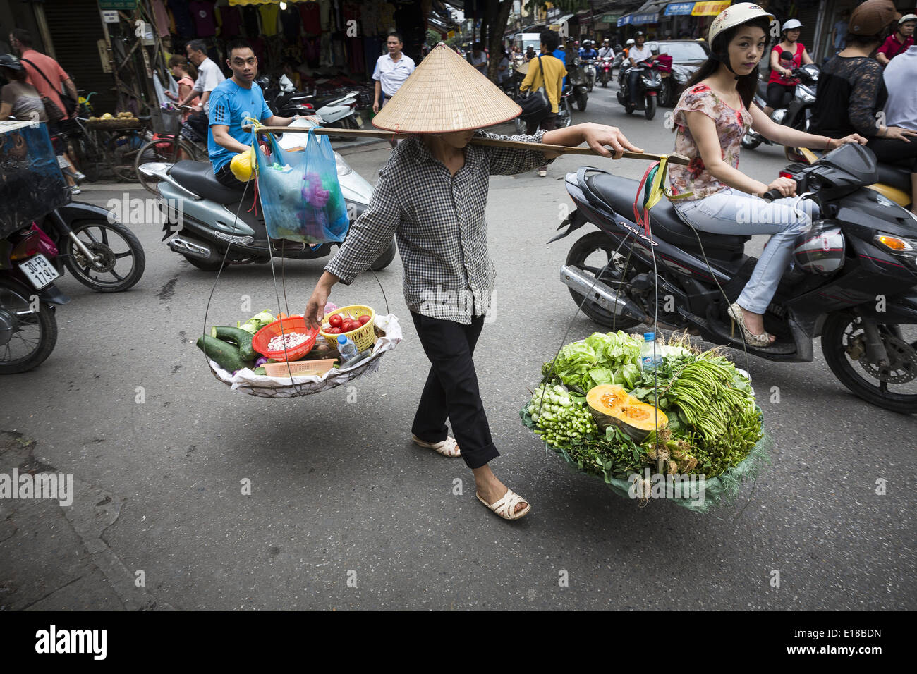 A vegetable vendor across the street loaded with wares for sale. Stock Photo