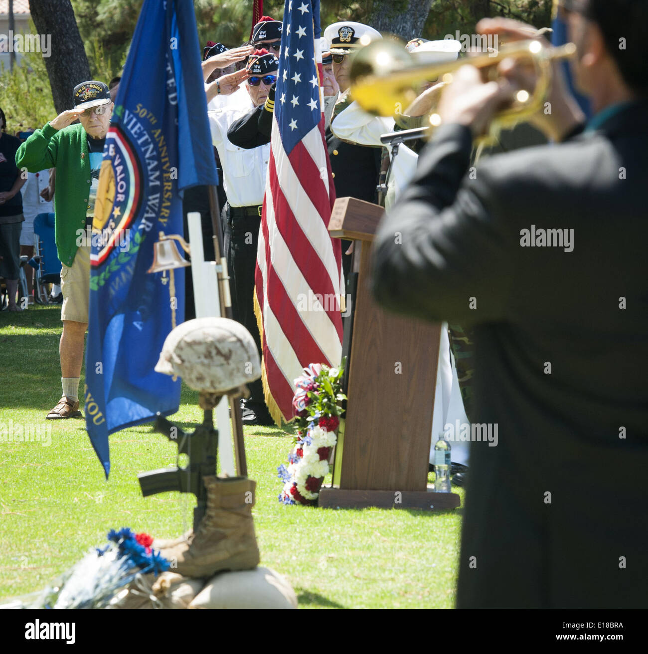 May 26, 2014 - Capistrano Beach/Dana Point, California, U.S - Marine Veteran Lt. Col. William R. Duncan, salutes along with other veterans, as Taps are played in honor and remembrance of America's war dead on Monday morning. Duncan served in WW II, Korea and Vietnam. David Longoria, of Pasadena, plays Taps, a traditional Memorial Day honor, on trumpet----Dana Point's Veterans of Foreign Wars Post 9934, along with the Ladies Auxiliary and the City of Dana Point, hosted this year's Memorial Day Ceremony at Pines Park in Capistrano Beach. Credit:  ZUMA Press, Inc./Alamy Live News Stock Photo