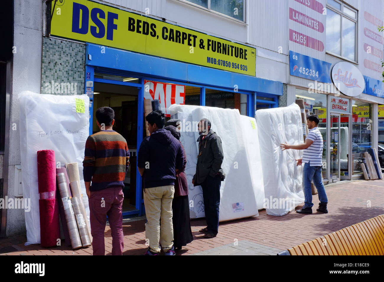 people looking at mattresses on sale in Luton Stock Photo Alamy