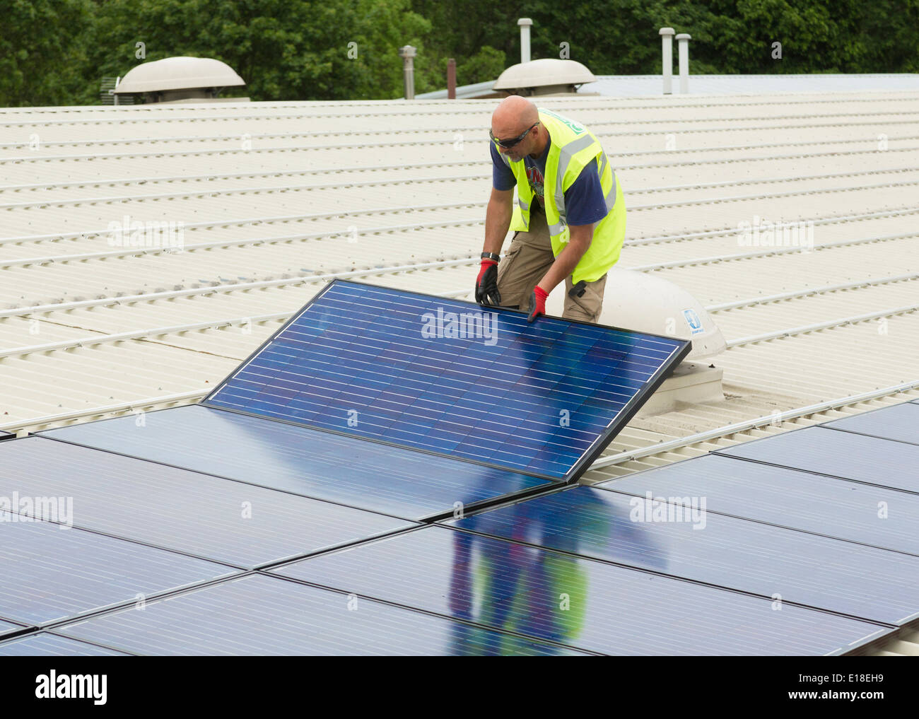 photovoltaic solar panels being installed on a roof Stock Photo