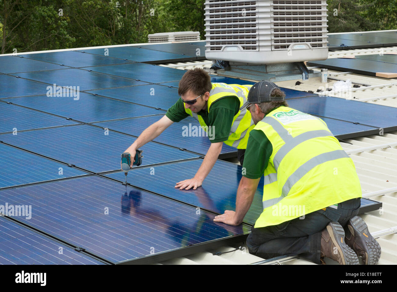 photovoltaic solar panels being installed on a roof Stock Photo