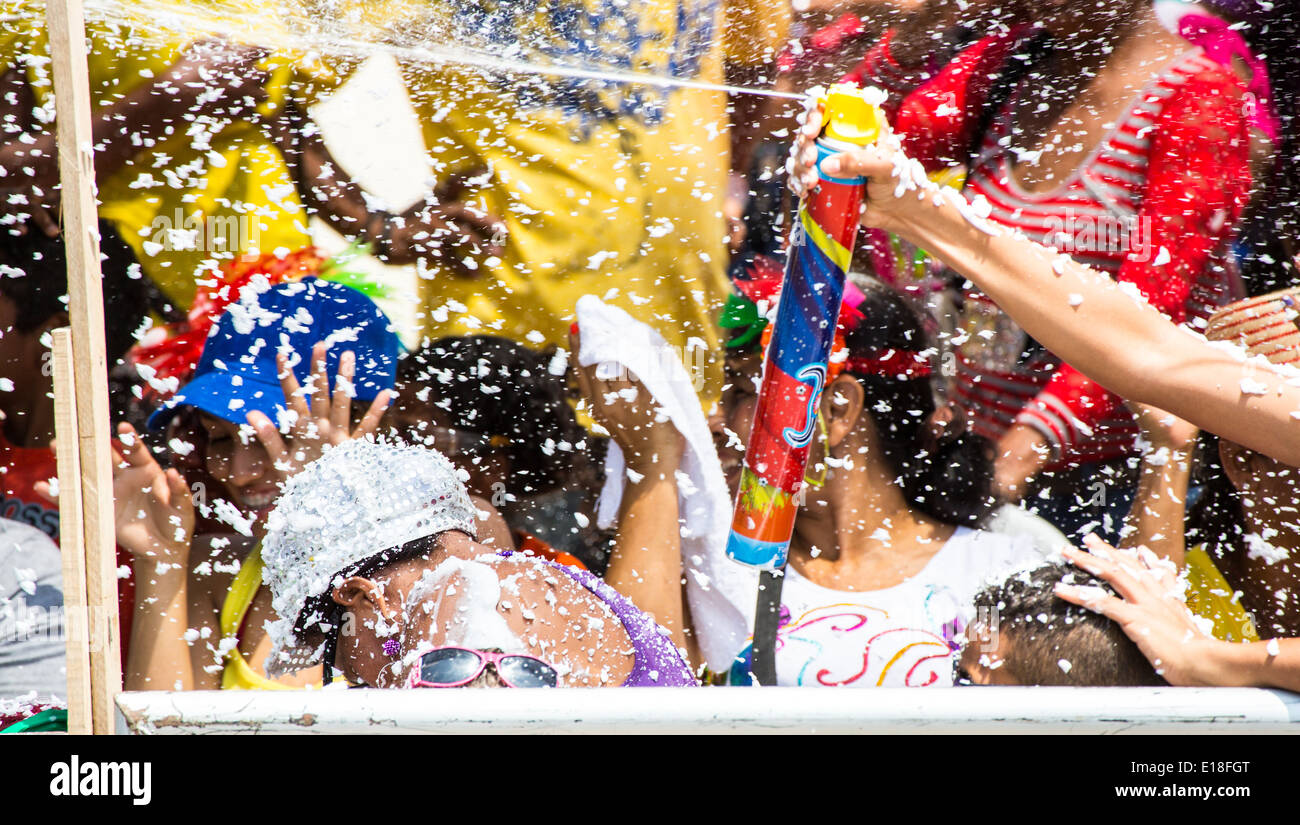 Barranquilla, Colombia - March 1, 2014 - Families and friends battle with white foam in the stands of the Barranquilla Carnival. The foam is basically soap and water sprayed from an arosol can. Stock Photo
