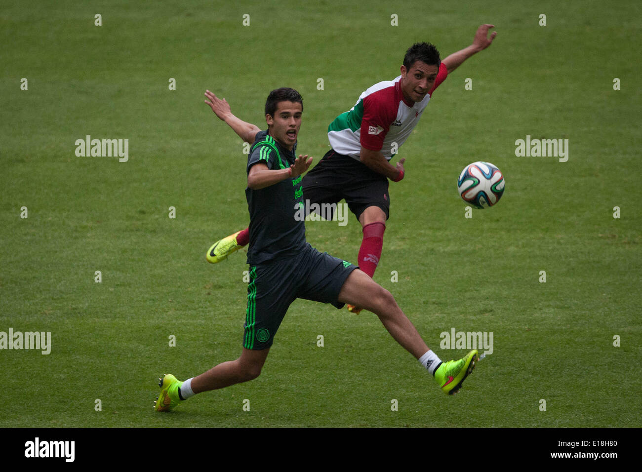Mexico City, Mexico. 26th May, 2014. Player Diego Reyes (front) of Mexico's national soccer team, takes part in a training session before the Brazil 2014 FIFA World Cup, in the Azteca Stadium, in Mexico City, capital of Mexico, on May 26, 2014. Credit:  Pedro Mera/Xinhua/Alamy Live News Stock Photo