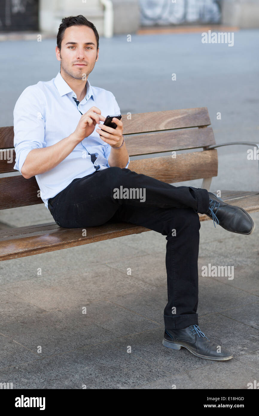Good-looking man checking his smartphone Stock Photo