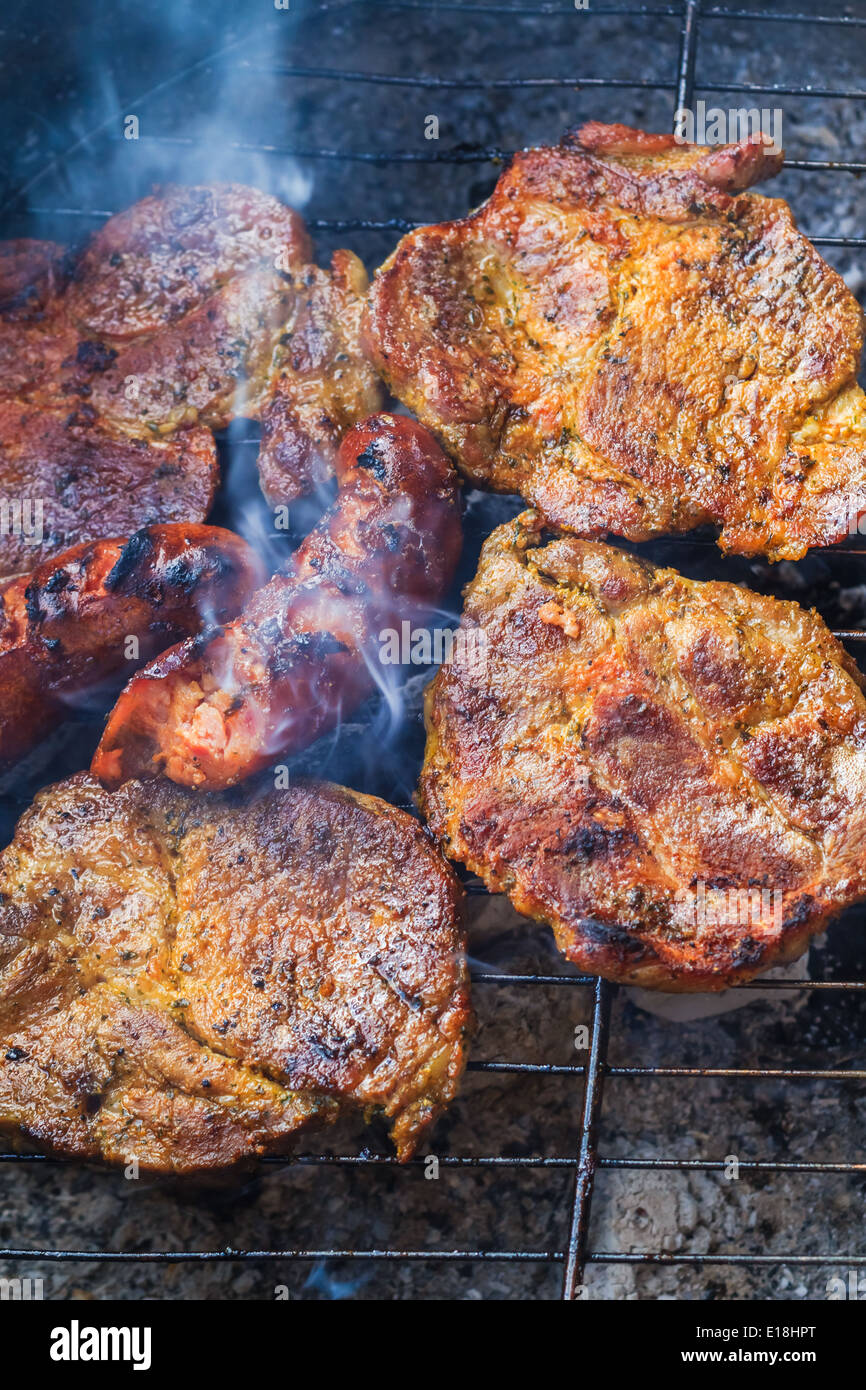 Barbecue in the garden. Process of cooking meat on grill Stock Photo
