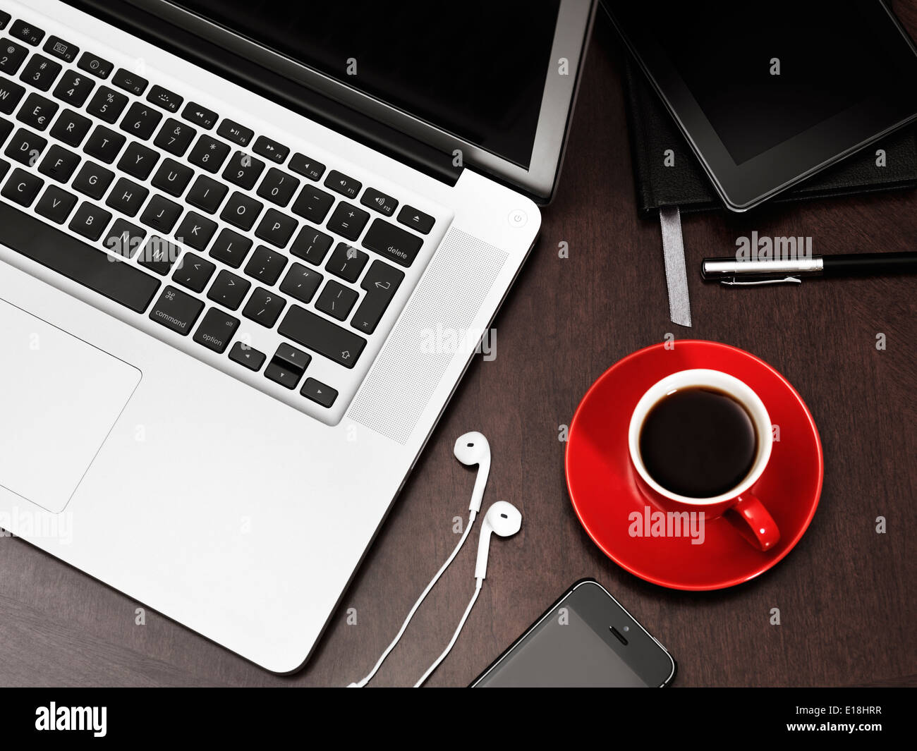 Apple macbook laptop computer iPhone with earphones Kindle Fire tablet and a red cup of coffee on a desk still life Stock Photo Alamy