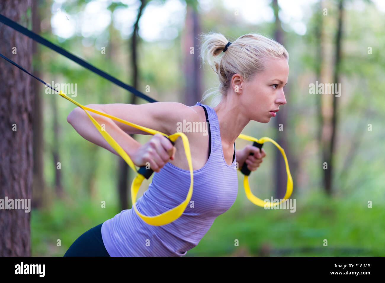 Training with fitness straps outdoors. Stock Photo
