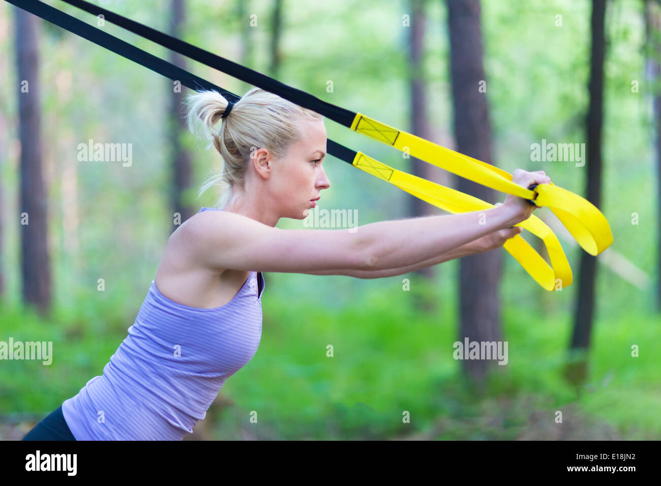 Training with fitness straps outdoors. Stock Photo