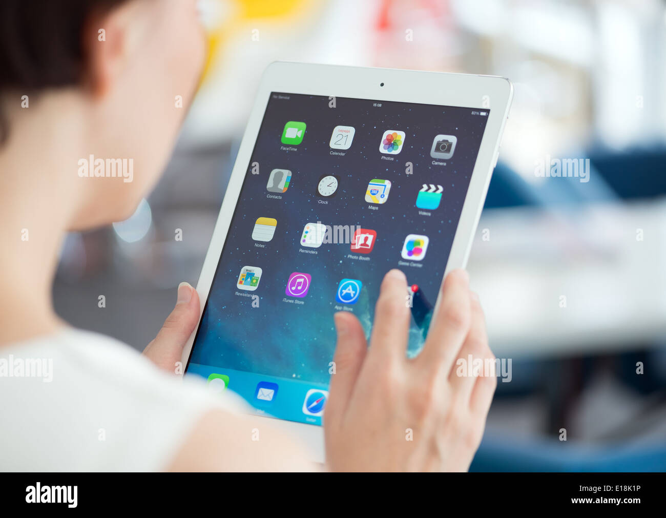 Woman holding brand new white Apple iPad Air, the most advanced digital tablet in part of the iPad line Stock Photo