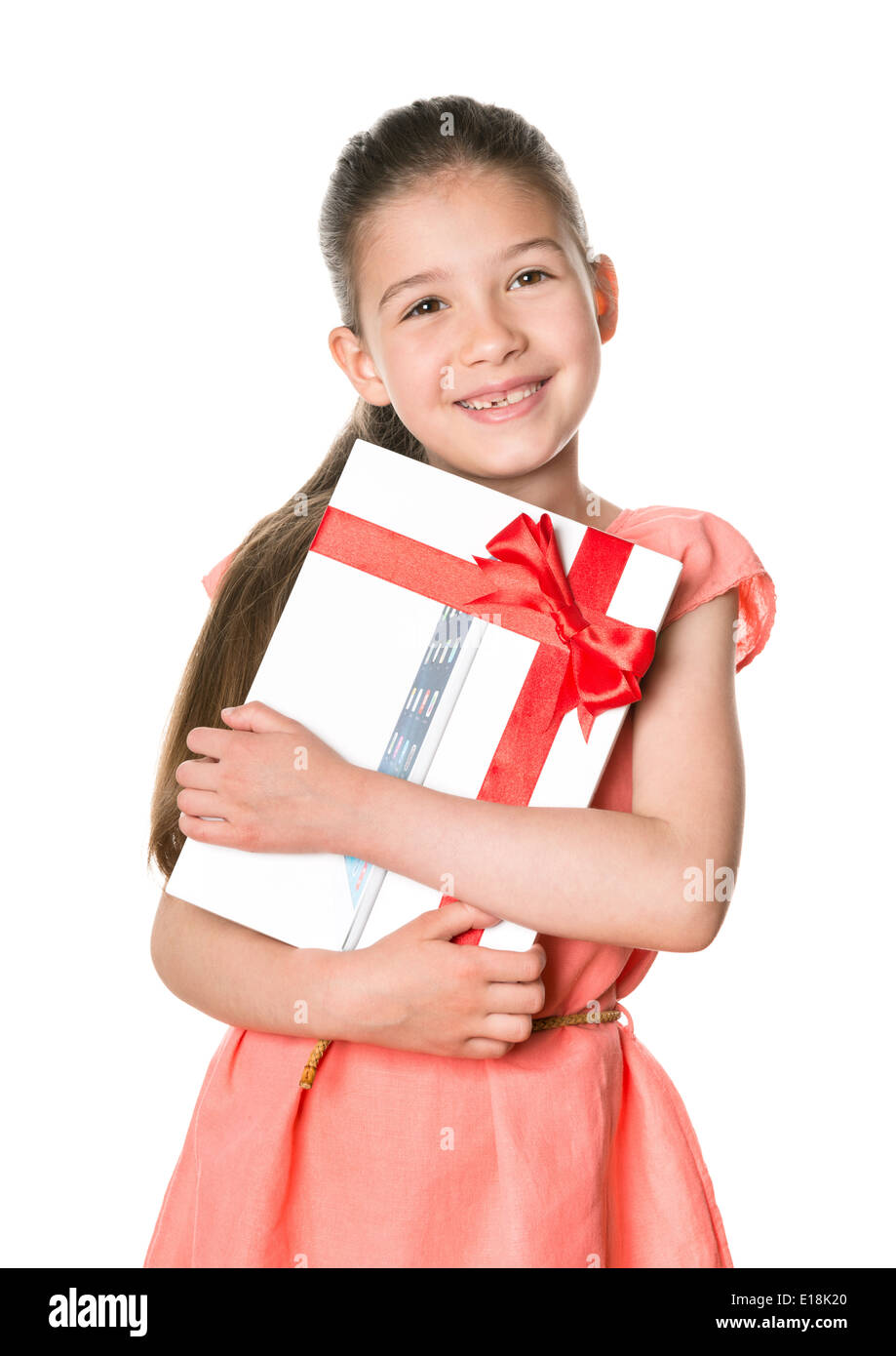 Smiling little girl holding in hands brand new Apple iPad Air as birthday present Stock Photo
