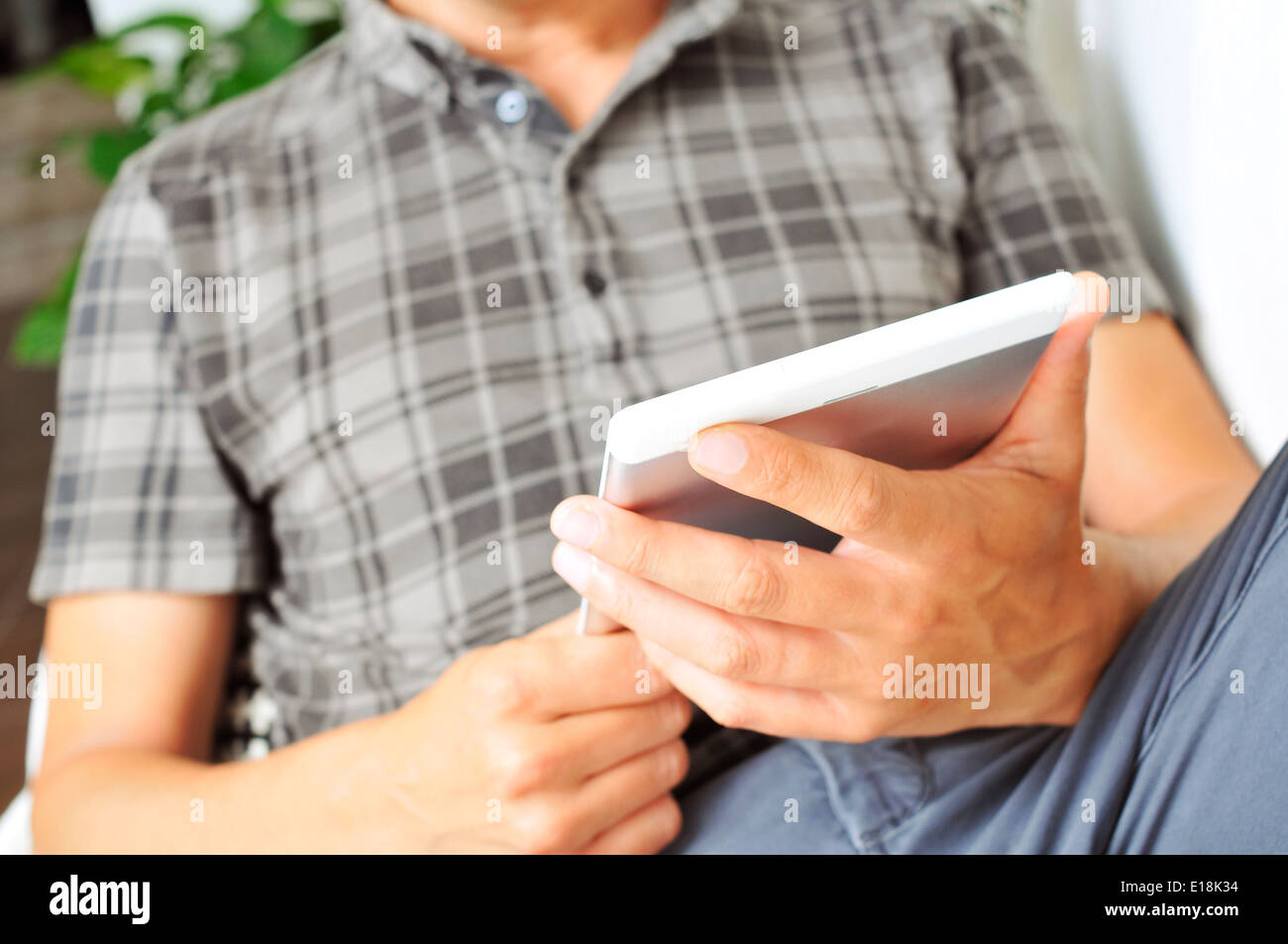 young man using a tablet computer Stock Photo