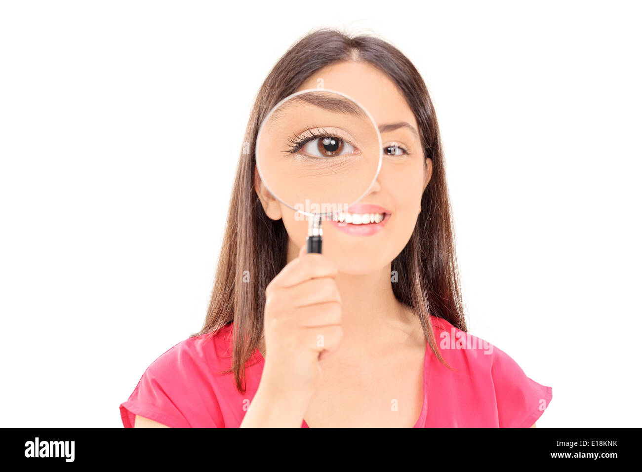 Young woman looking through a magnifying glass Stock Photo - Alamy