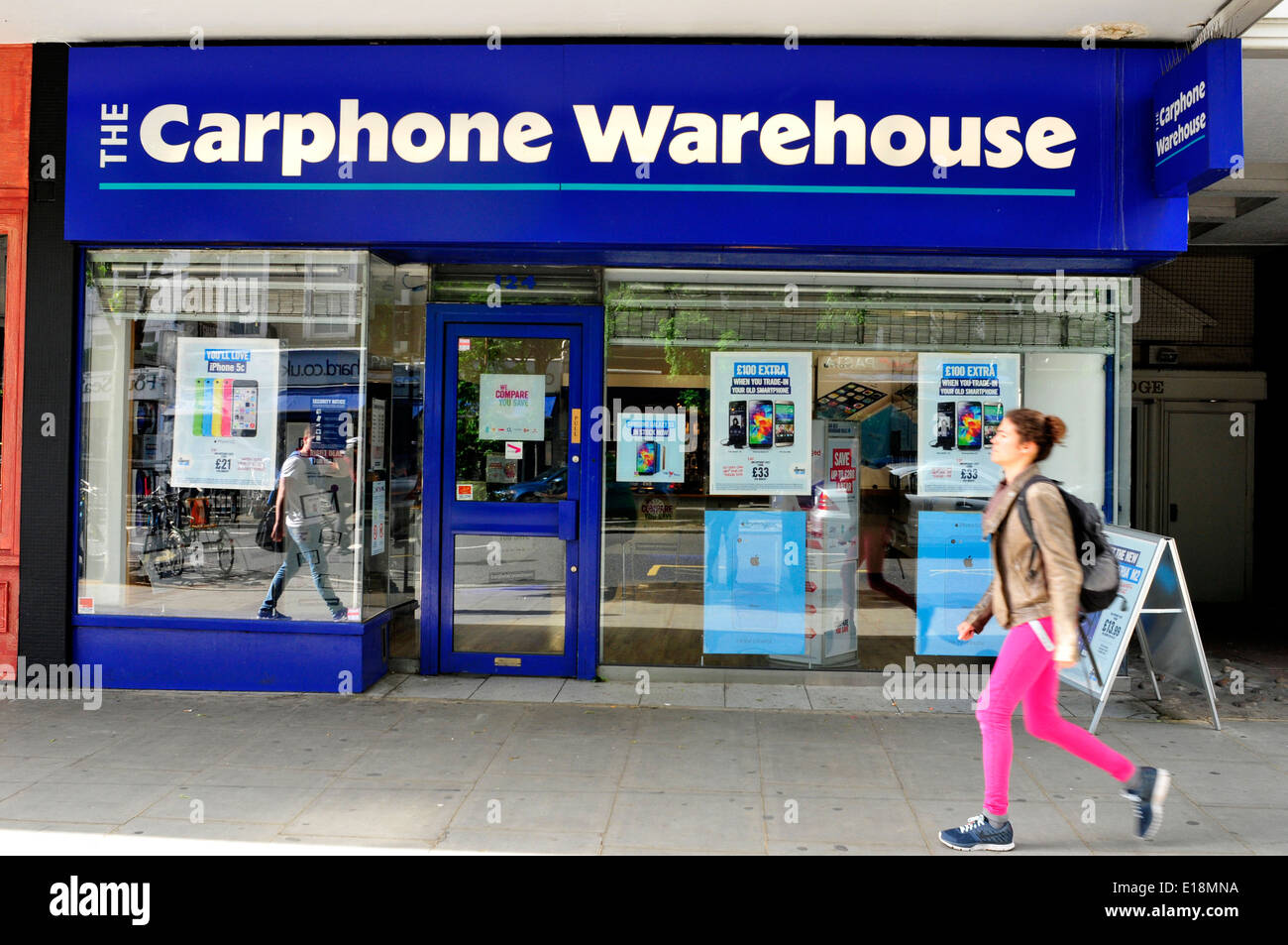 A woman walks past carphone warhouse in London, UK Stock Photo