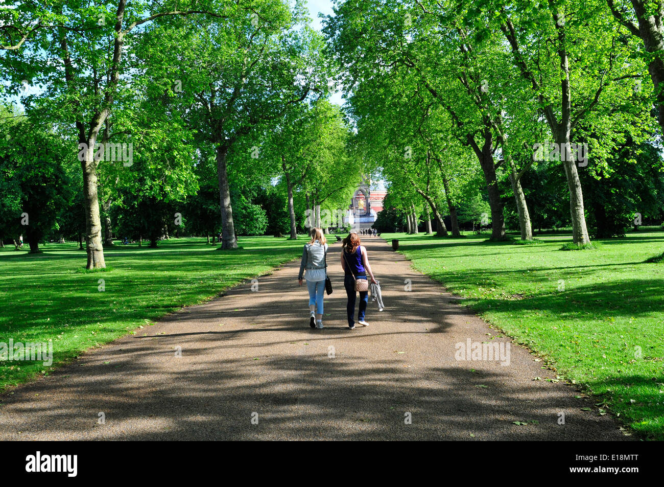 Two women walking in Kensington Gardens, London, UK Stock Photo