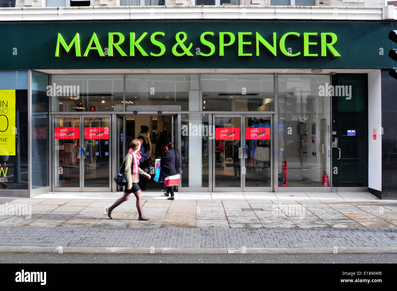 A woman walks in front of Marks & Spencer store, Hammersmith, London, UK Stock Photo