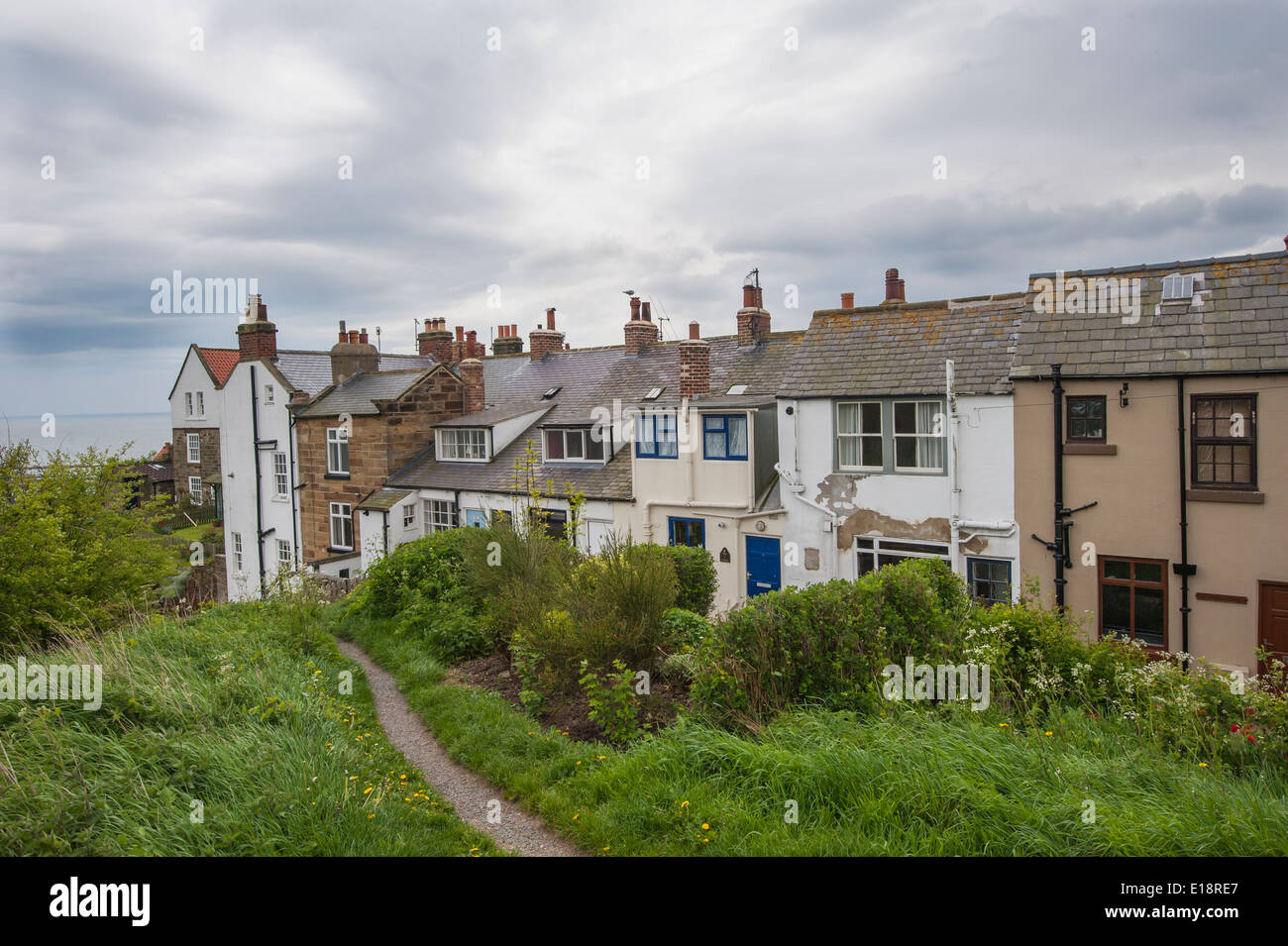 Row of terraced houses on coast in english rural countryside with overcast sky Stock Photo