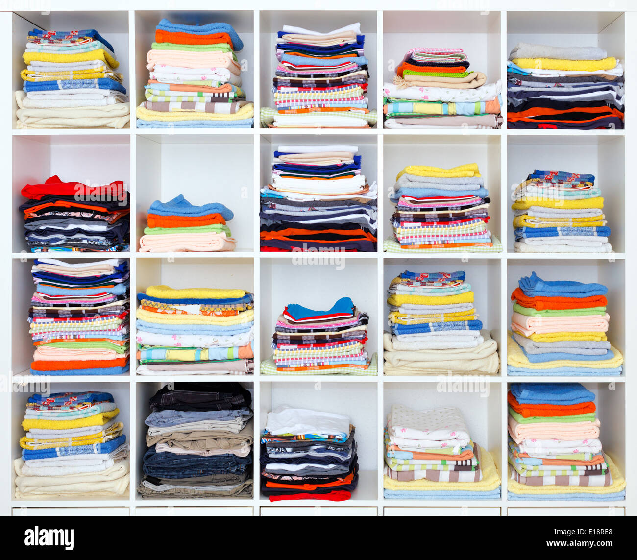 towels, bed sheets and clothes on the shelf Stock Photo