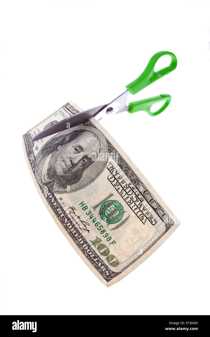 Ein Dollar Geldschein und eine Schere. Symbolphoto fuer Steuern und Abgaben Stock Photo