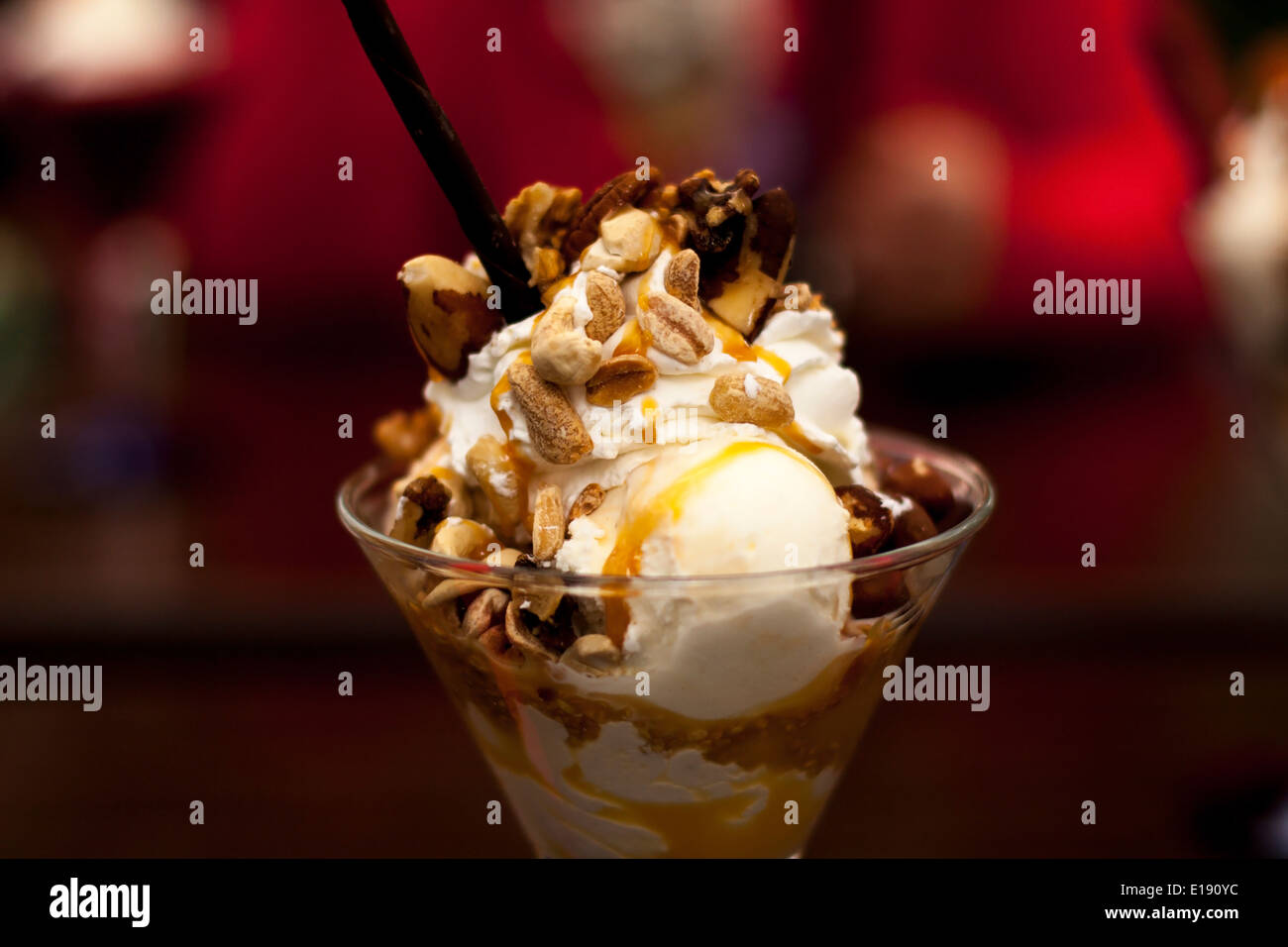 Delicious vanilla ice cream topped with caramel and various nuts Stock