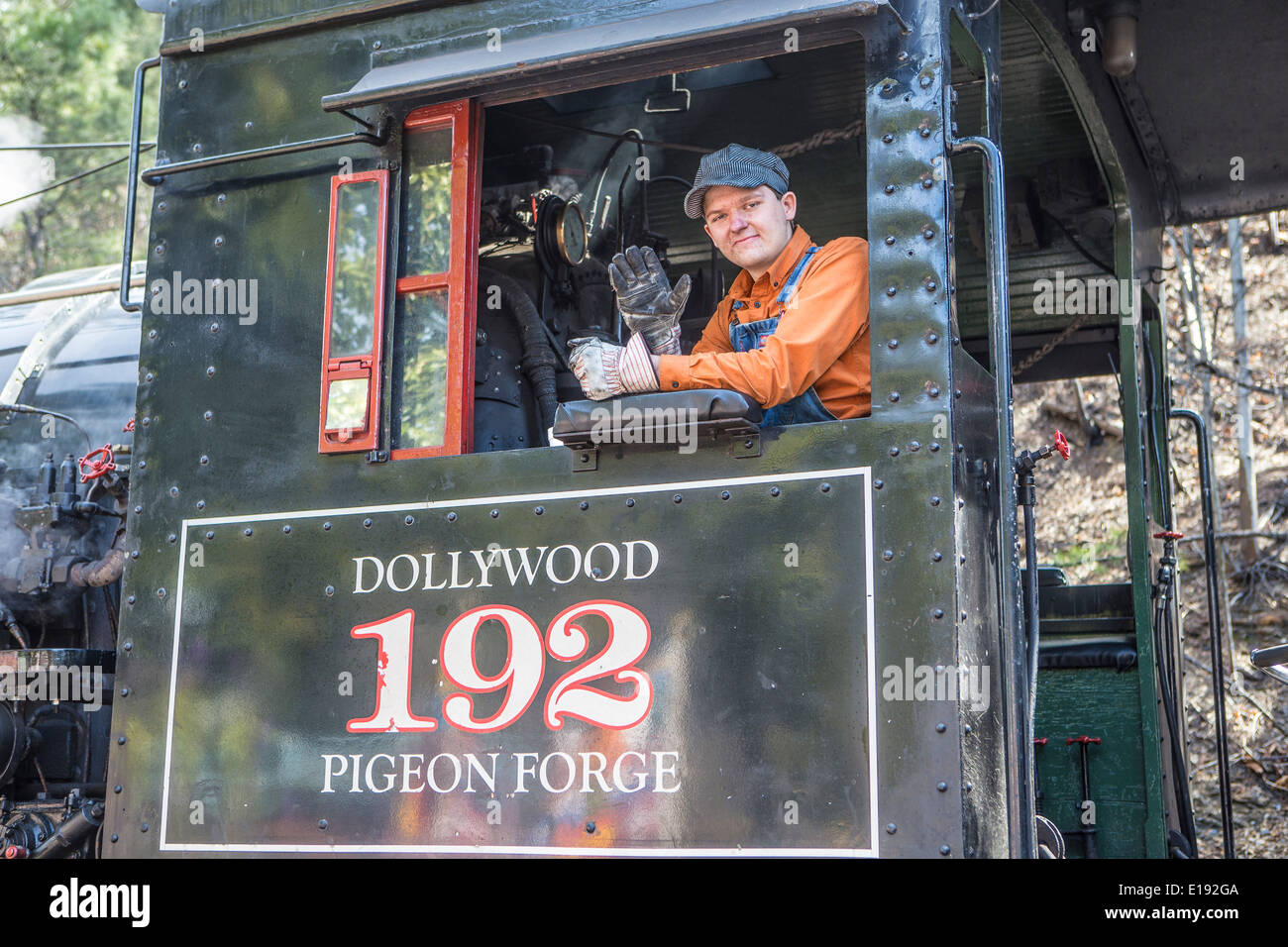 A train conductor waves aboard the narrow gauge Dollywood Express steam