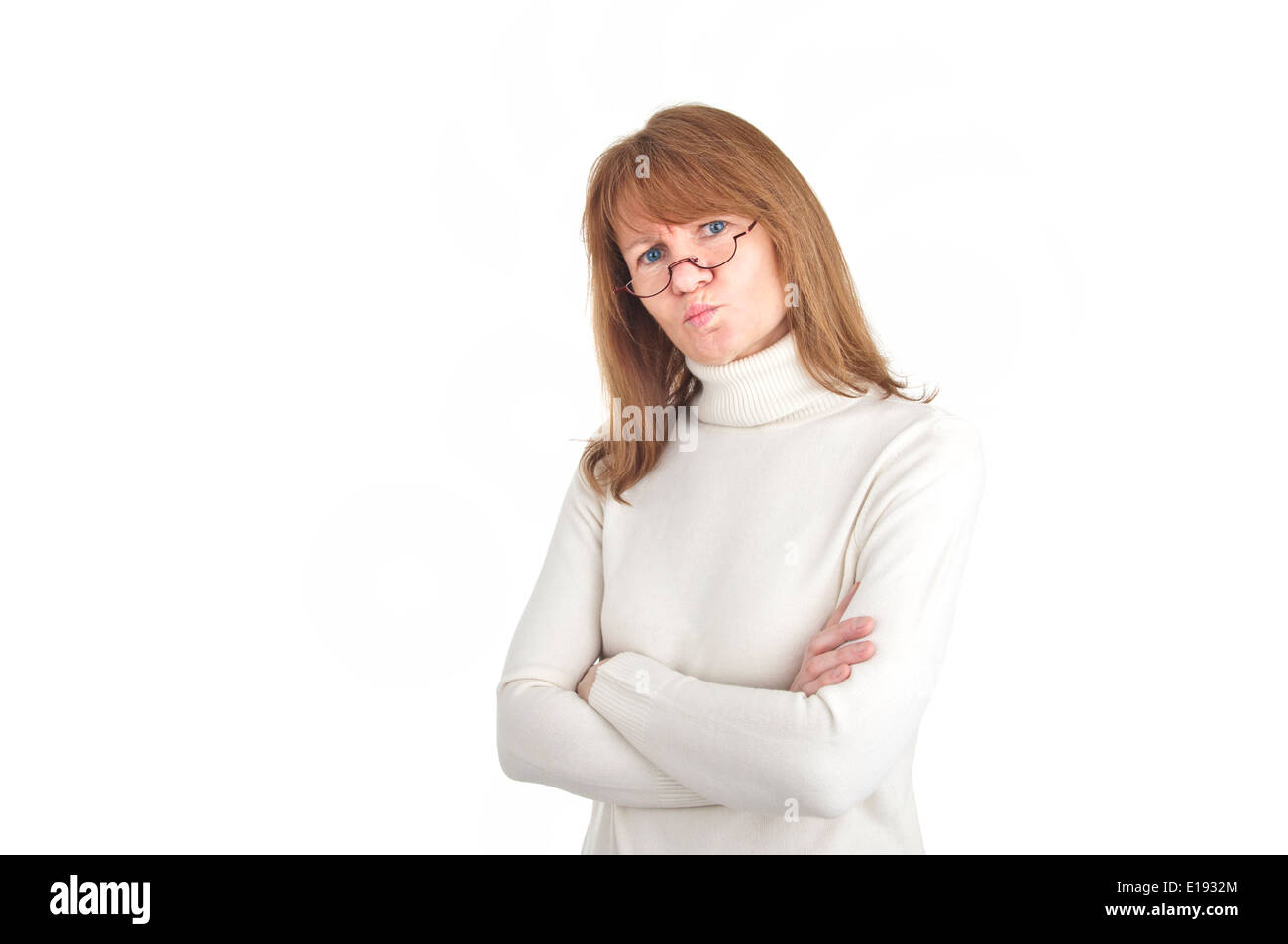 Woman with reading glasses looking doubtfully into the camera - isolated over white Stock Photo