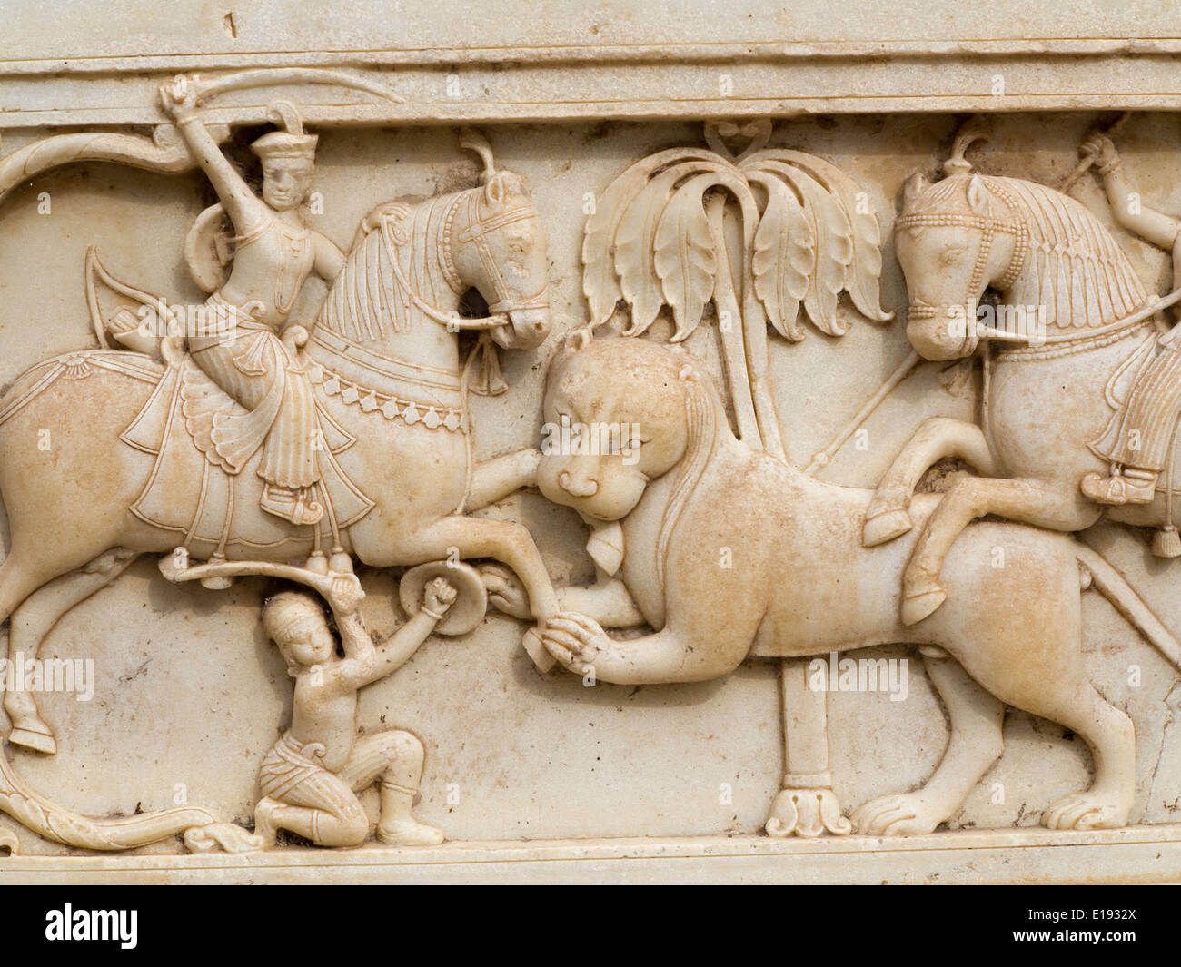 India, Rajasthan, Jaipur, Gaitore Ki Chhatriyan, Royal Cremation Ground, detail of carved marble lion or tiger hunting scene Stock Photo