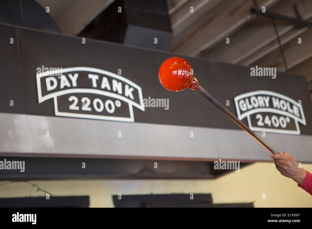A man blows glass at the Rainbow Factory blown glass shop in Dollywood