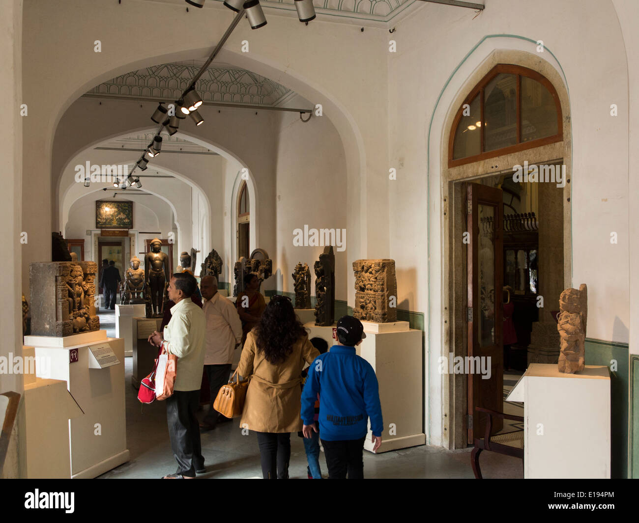 India, Rajasthan, Jaipur, Albert Hall Museum, visitors looking at exhibits in wood carving gallery Stock Photo