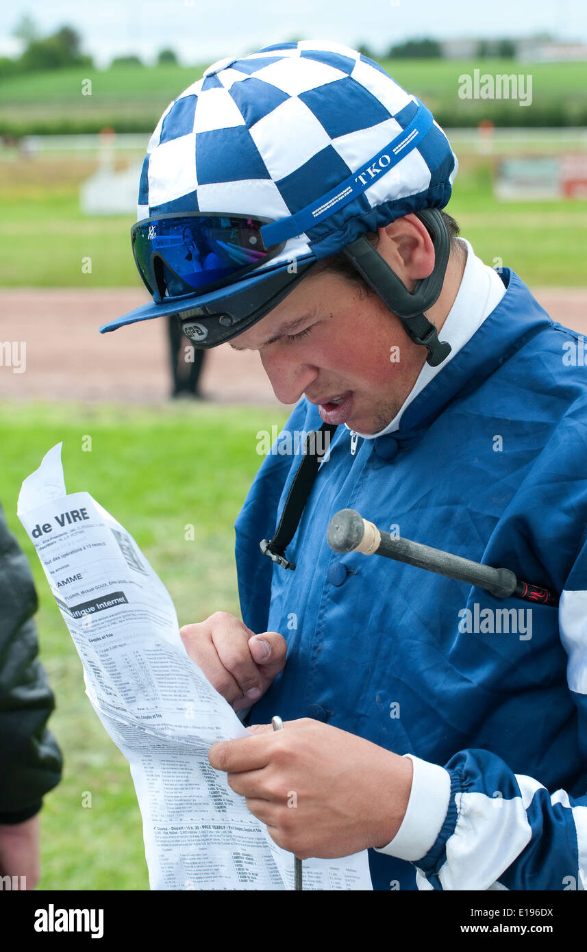 jockey reading racing paper at vire racecourse, calvados, normandy, france Stock Photo