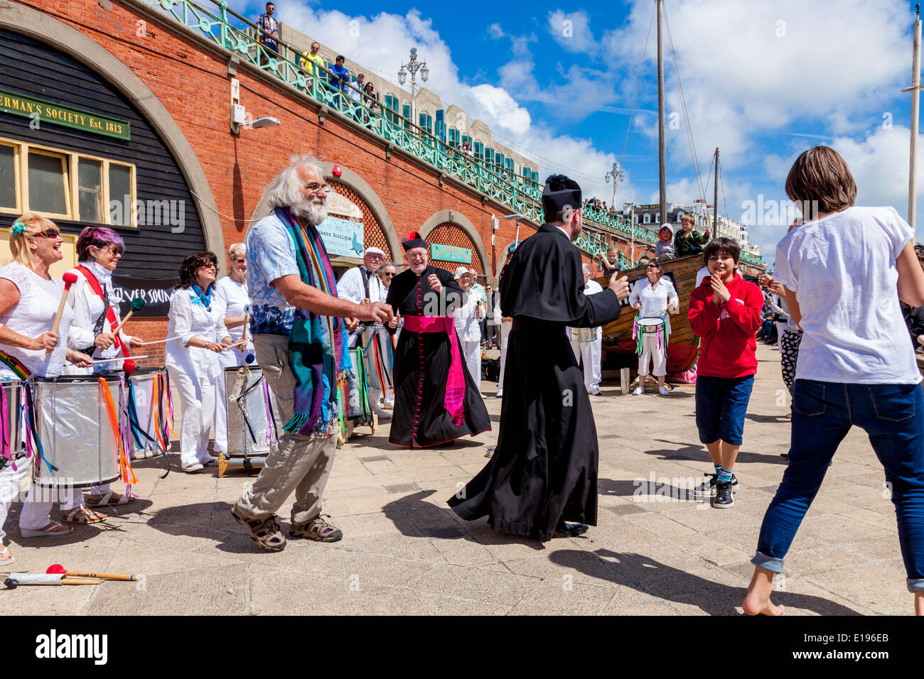 Local Parish Priests Dancing To The Silver Sounds Samba Band At The Mackerel Fayre, Brighton Seafront, Sussex, England Stock Photo