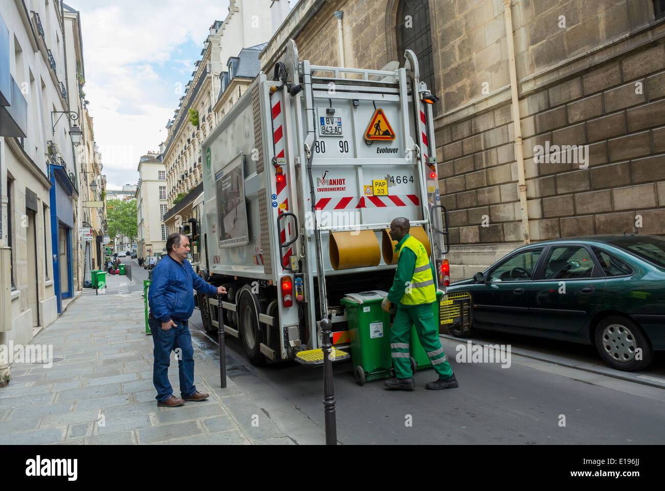 Paris, France, Marais Area, Street Scene, Glass Recycling French Truck garbage man, Pick up wheely bin on Sidewalk Stock Photo