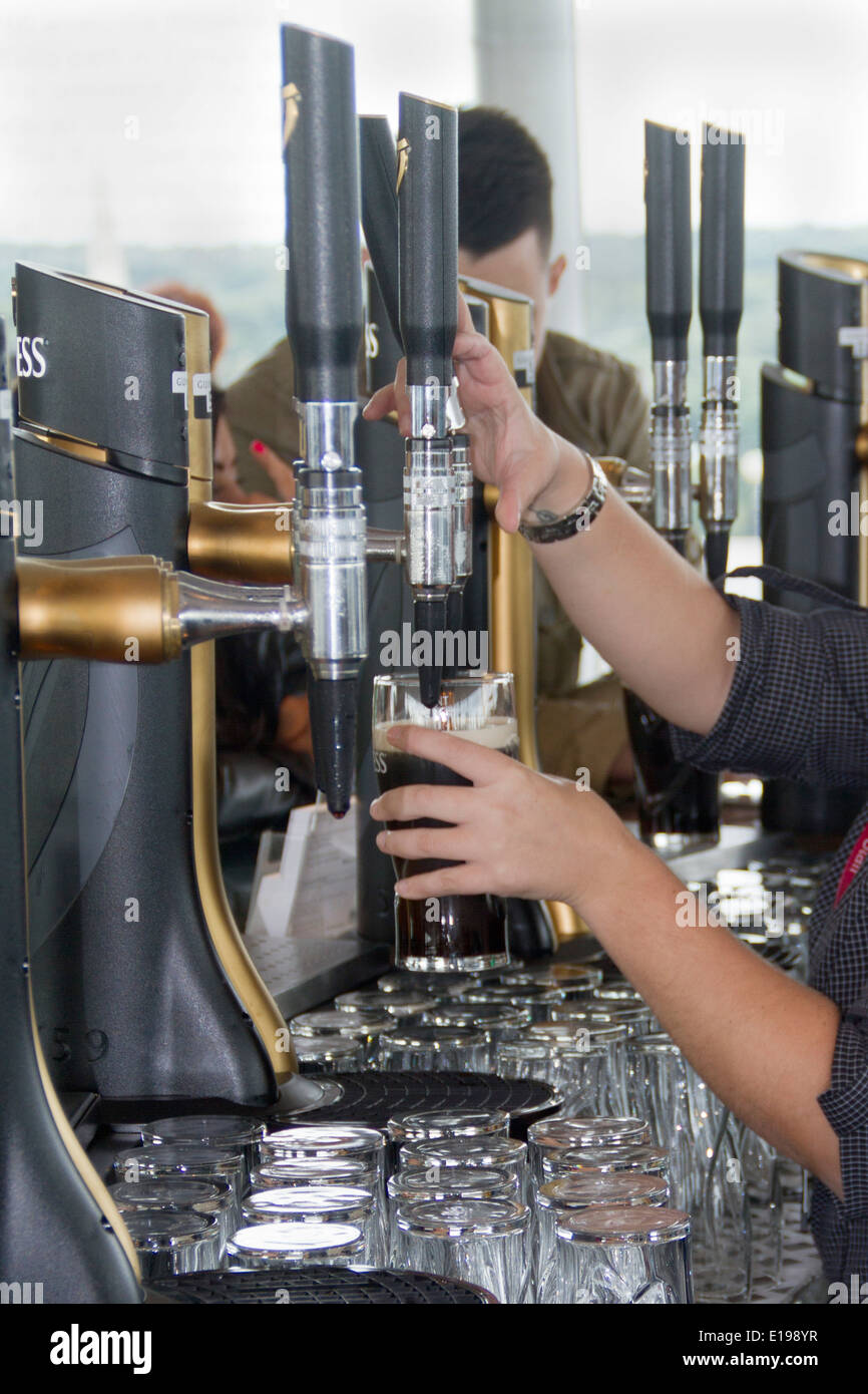 Pouring Guinness on tap to visitors at the Guinnes Storehouse Dublin,Ireland Stock Photo