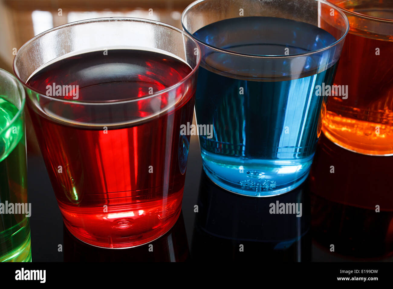 Close up of Multi colored Alcoholic shooters in shot glasses great example of a Drinks offer in a local bar. Stock Photo